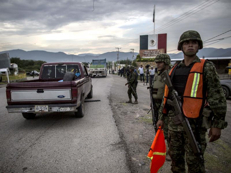 Groups of rural and community police arrive in the city of Iguala on Tuesday to help in the search for 43 students who disappeared after a confrontation with local police on Sept. 26. Groups of rural and community police arrive in the city of Iguala on Tuesday to help in the search for 43 students who disappeared after a confrontation with local police on Sept. 26.