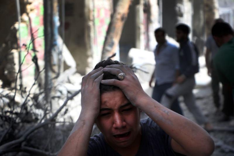 Syrian civilians are seen in the aftermath of renewed attacks on an opposition-controlled area in Aleppo on Tuesday. Syrian civilians are seen in the aftermath of renewed attacks on an opposition-controlled area in Aleppo on Tuesday.