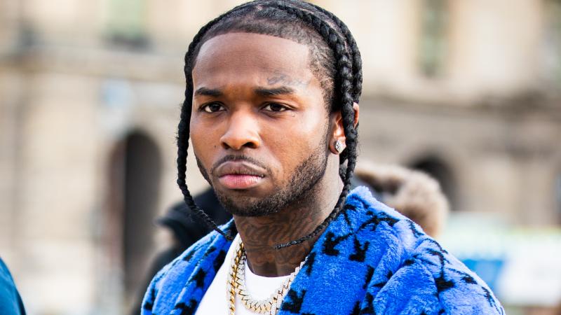Los Angeles police say they have arrested five people in connection with the February shooting death of rapper Pop Smoke. The late musician is seen here during Paris Fashion Week's men's fall-winter shows in January. Los Angeles police say they have arrested five people in connection with the February shooting death of rapper Pop Smoke. The late musician is seen here during Paris Fashion Week's men's fall-winter shows in January.