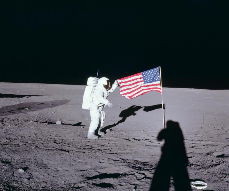 From NASA: Apollo 12 commander Charles "Pete" Conrad unfurls the United States flag on the lunar surface during the first extravehicular activity on Nov. 19, 1969. From NASA: Apollo 12 commander Charles "Pete" Conrad unfurls the United States flag on the lunar surface during the first extravehicular activity on Nov. 19, 1969.