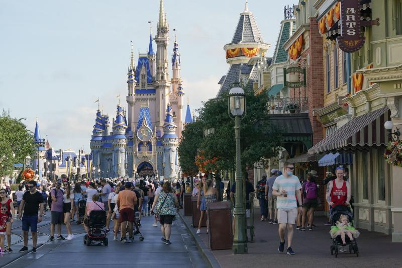 Guests stroll along Main Street at the Magic Kingdom theme park at Walt Disney World. The park celebrates its 50th anniversary on Oct. 1, 2021. Guests stroll along Main Street at the Magic Kingdom theme park at Walt Disney World. The park celebrates its 50th anniversary on Oct. 1, 2021.