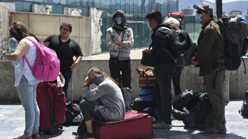 Travelers wait for a charter flight coordinated by the United States embassy to take them home from Guatemala City on Monday. Travelers wait for a charter flight coordinated by the United States embassy to take them home from Guatemala City on Monday.