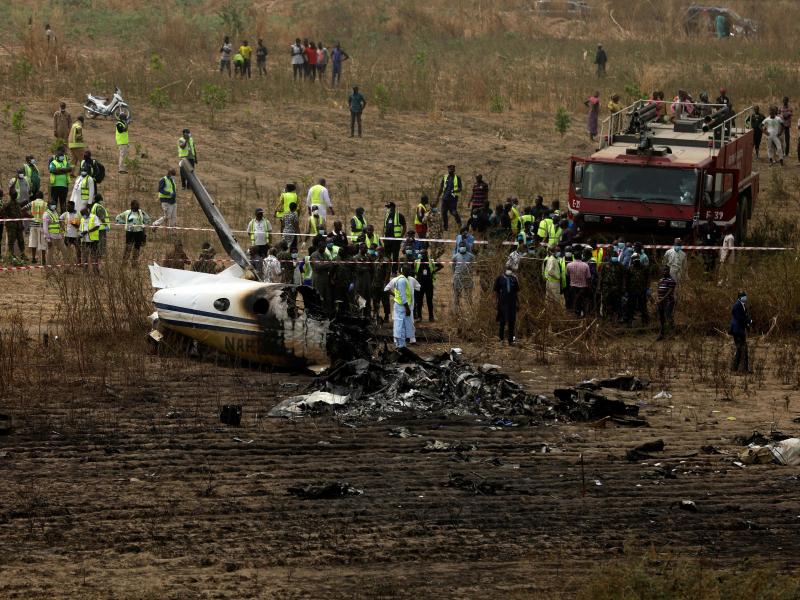 Emergency personnel work at the scene a Nigerian military aircraft crash near Abuja, Nigeria, on Sunday. All seven people on board were killed. Emergency personnel work at the scene a Nigerian military aircraft crash near Abuja, Nigeria, on Sunday. All seven people on board were killed.