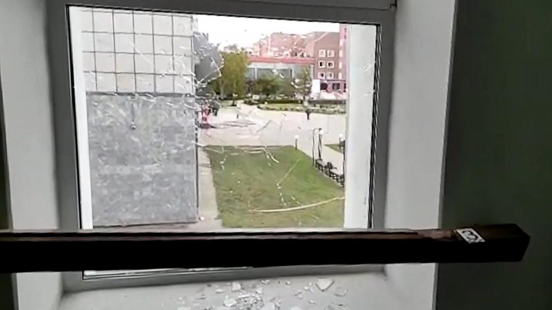 A broken window is pictured at the Perm State University where an unidentified man opened fire, killing at least eight people and injuring 24 others. A broken window is pictured at the Perm State University where an unidentified man opened fire, killing at least eight people and injuring 24 others.