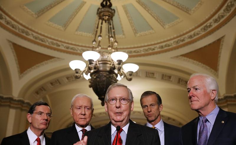 Senate Majority Leader Mitch McConnell, R-Ky. (center), gathered the support he needed on Friday to pass the GOP tax bill in the Senate. Now that legislation must be reconciled with the House version. Senate Majority Leader Mitch McConnell, R-Ky. (center), gathered the support he needed on Friday to pass the GOP tax bill in the Senate. Now that legislation must be reconciled with the House version.