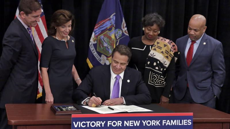 New York Gov. Andrew Cuomo signed a law Monday that will establish a paid-family-leave policy and gradually raise New York's minimum wage, at the Javits Convention Center in New York City. New York Gov. Andrew Cuomo signed a law Monday that will establish a paid-family-leave policy and gradually raise New York's minimum wage, at the Javits Convention Center in New York City.