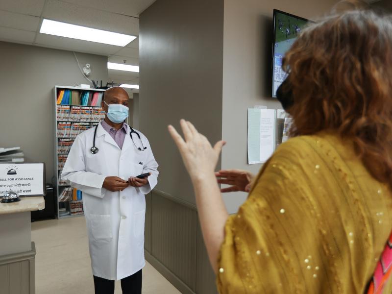 Dr. Naresh Aggarwal talks in April with Jennifer Bain, who volunteered for a study of Medicago's COVID-19 vaccine in Toronto. Dr. Naresh Aggarwal talks in April with Jennifer Bain, who volunteered for a study of Medicago's COVID-19 vaccine in Toronto.