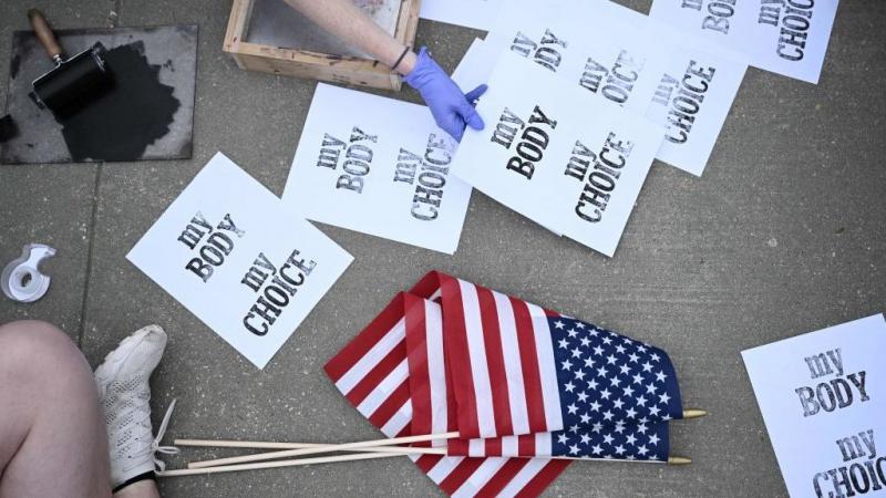 Pro-choice demonstrators make signs Tuesday in front of the U.S. Supreme Court in Washington. Pro-choice demonstrators make signs Tuesday in front of the U.S. Supreme Court in Washington.