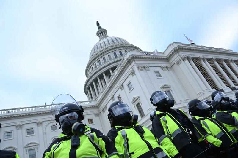 Police stand in a line outside the U.S. Capitol on Jan. 6, 2021. Police stand in a line outside the U.S. Capitol on Jan. 6, 2021.