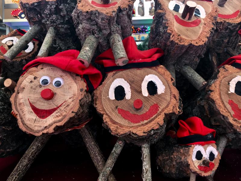 Caga Tiós, Catalan Christmas logs stacked up at a market in Girona, Spain. Caga Tiós, Catalan Christmas logs stacked up at a market in Girona, Spain.