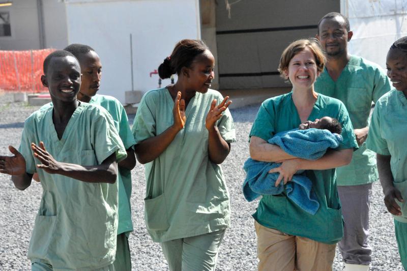 Medical workers surround 34-day-old Noubia, the last known patient to contract Ebola in Guinea, as she was released from a Doctors Without Borders treatment center in Conakry on Nov. 28. Medical workers surround 34-day-old Noubia, the last known patient to contract Ebola in Guinea, as she was released from a Doctors Without Borders treatment center in Conakry on Nov. 28.