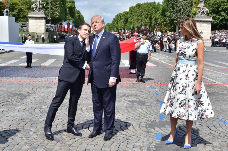 French President Emmanuel Macron (left) shakes hands with President Trump, next to first lady Melania Trump, during the annual Bastille Day military parade in Paris on July 14, 2017. Trump is hosting Macron in Washington this week for the first official s French President Emmanuel Macron (left) shakes hands with President Trump, next to first lady Melania Trump, during the annual Bastille Day military parade in Paris on July 14, 2017. Trump is hosting Macron in Washington this week for the first official s