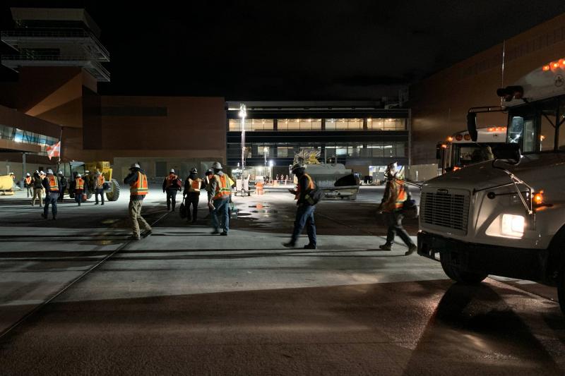 RK workers depart a bus on their way to the job site at a new airport under construction in Salt Lake City. RK workers depart a bus on their way to the job site at a new airport under construction in Salt Lake City.