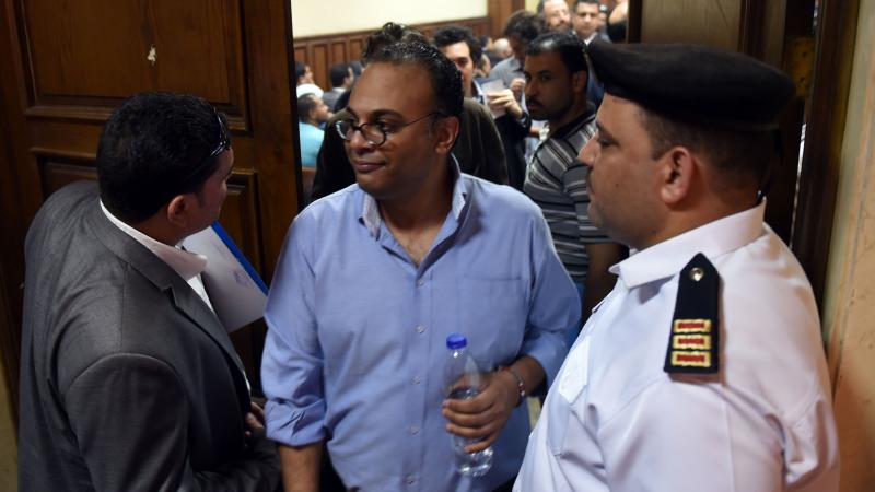 Egyptian human rights activist Hossam Bahgat (center) leaves a Cairo courtroom on Wednesday after a hearing in which the state requested a travel ban and freeze of his assests. The government has taken action against a number of groups and activists in wh Egyptian human rights activist Hossam Bahgat (center) leaves a Cairo courtroom on Wednesday after a hearing in which the state requested a travel ban and freeze of his assests. The government has taken action against a number of groups and activists in wh