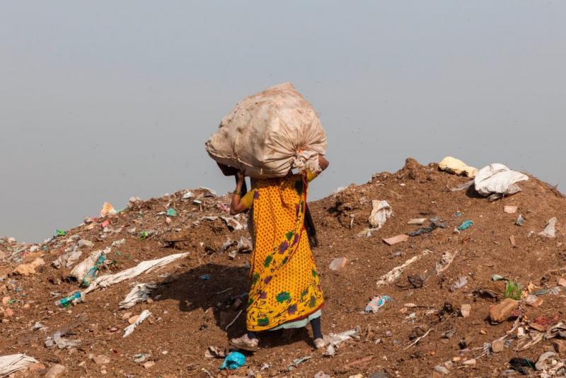 A trash picker carries a sack of recyclable materials she collected at the Ghazipur landfill in the east of New Delhi. A trash picker carries a sack of recyclable materials she collected at the Ghazipur landfill in the east of New Delhi.