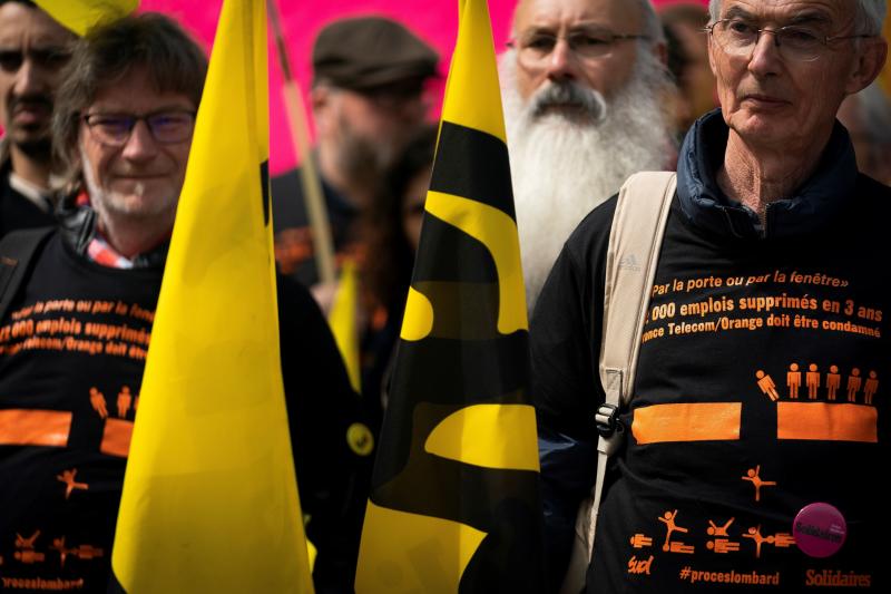 Union members gather in front of a Paris courthouse on May 6, as several former senior employees of the then-named company France Télécom go on trial for alleged "moral harassment," a decade after a series of suicides occurred at the firm between 2008 a Union members gather in front of a Paris courthouse on May 6, as several former senior employees of the then-named company France Télécom go on trial for alleged "moral harassment," a decade after a series of suicides occurred at the firm between 2008 a
