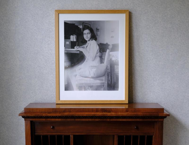 A photo of Anne Frank stands on a replica of the writing desk she once used in her family's former apartment in Amsterdam, during an event to mark what would have been Anne Frank's 90th birthday, in Amsterdam in June 2019. A photo of Anne Frank stands on a replica of the writing desk she once used in her family's former apartment in Amsterdam, during an event to mark what would have been Anne Frank's 90th birthday, in Amsterdam in June 2019.