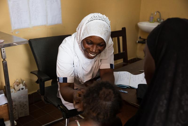 Nabia Drammeh, 27, a nurse, talks with Maram Ceesay, and her granddaughter, Awa at the Brufut Minor Health Center outside of Banjul, the Gambia. Awa's mother passed away during childbirth leaving her Maram to look after her. The 2-year-old is being treate Nabia Drammeh, 27, a nurse, talks with Maram Ceesay, and her granddaughter, Awa at the Brufut Minor Health Center outside of Banjul, the Gambia. Awa's mother passed away during childbirth leaving her Maram to look after her. The 2-year-old is being treate