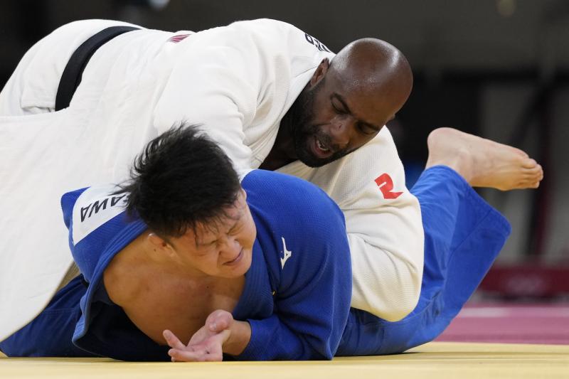 Riner (top) and Japan's Hisayoshi Harasawa compete Friday during the men's over 100-kilogram bronze medal judo match. Riner (top) and Japan's Hisayoshi Harasawa compete Friday during the men's over 100-kilogram bronze medal judo match.