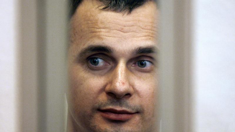 Ukrainian film director Oleg Sentsov is seen inside of the defendant's cage in a military courtroom on July 27, 2015. He is currently serving a 20-year sentence. Ukrainian film director Oleg Sentsov is seen inside of the defendant's cage in a military courtroom on July 27, 2015. He is currently serving a 20-year sentence.