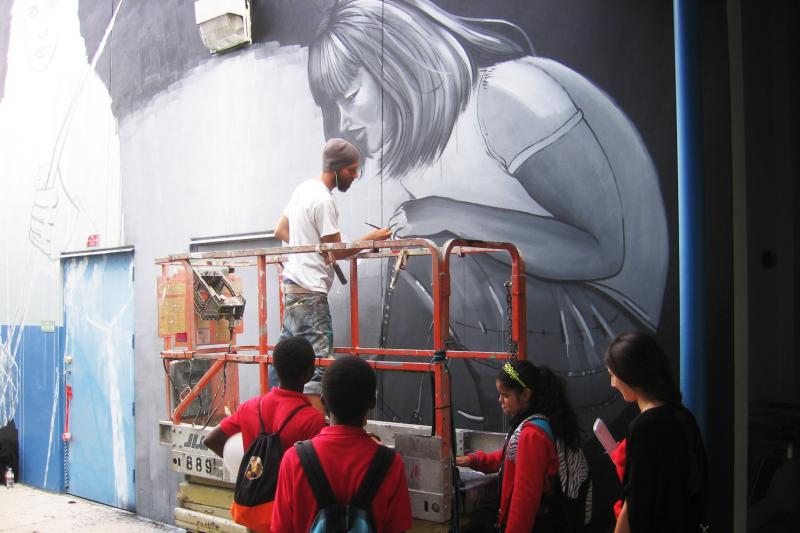 Leza One paints a mural on a wall of Jose de Diego Middle School in Miami's Wynwood neighborhood. It's a project that coincides with the citywide Art Basel fair. Leza One paints a mural on a wall of Jose de Diego Middle School in Miami's Wynwood neighborhood. It's a project that coincides with the citywide Art Basel fair.