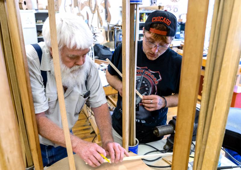 Paul Williams (left) helps Scott Beatty build his 'backpack' guitar. It has a smaller body, meant to easily fit in a pack. Beatty is in the Culture of Recovery program which teaches instrument making to people recovering from addiction. Paul Williams (left) helps Scott Beatty build his 'backpack' guitar. It has a smaller body, meant to easily fit in a pack. Beatty is in the Culture of Recovery program which teaches instrument making to people recovering from addiction.