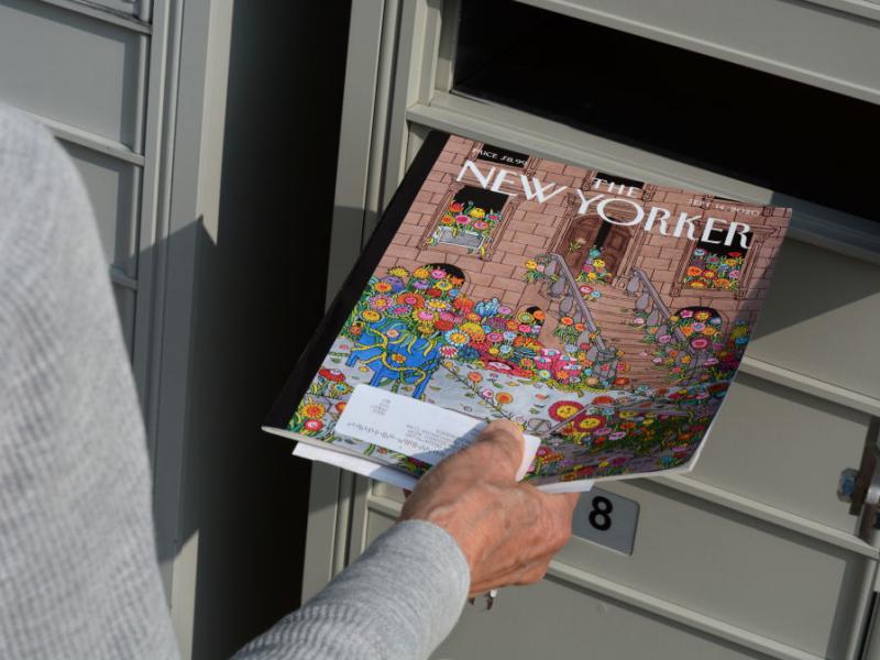 A woman retrieves a copy of The New Yorker magazine from her mailbox in Santa Fe, N.M., in 2020. A woman retrieves a copy of The New Yorker magazine from her mailbox in Santa Fe, N.M., in 2020.