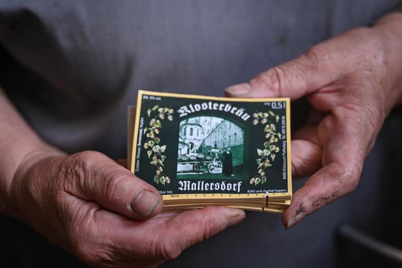Sister Doris holds labels of the beer bottles with a painting of the former nun who was running the brewery. Sister Doris holds labels of the beer bottles with a painting of the former nun who was running the brewery.