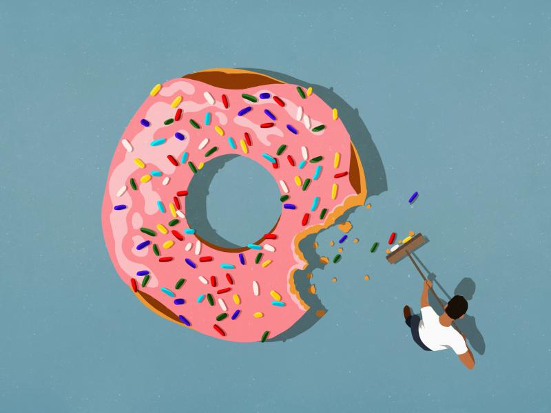 A pink donut with sprinkles with a bite out of it. A pink donut with sprinkles with a bite out of it.