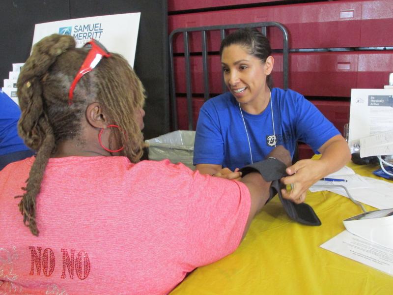 Diana Venegas, a nursing student at Samuel Merritt University, in Oakland, Calif., takes a patient's blood pressure at a recent health fair at Allen Temple Baptist Church. Diana Venegas, a nursing student at Samuel Merritt University, in Oakland, Calif., takes a patient's blood pressure at a recent health fair at Allen Temple Baptist Church.