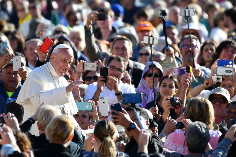 In his weekly audience, Pope Francis called for followers to put down their cellphones during Mass, and be more engaged in the Eucharist. The pontiff is pictured here arriving in the Vatican's St. Peter's Square last year. In his weekly audience, Pope Francis called for followers to put down their cellphones during Mass, and be more engaged in the Eucharist. The pontiff is pictured here arriving in the Vatican's St. Peter's Square last year.