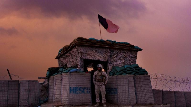 A U.S. Marine from the 1st Battalion, 8th Marines, Alpha Company looks out as an evening storm gathers above an outpost near Kunjak, in southern Afghanistan's Helmand province. A U.S. Marine from the 1st Battalion, 8th Marines, Alpha Company looks out as an evening storm gathers above an outpost near Kunjak, in southern Afghanistan's Helmand province.