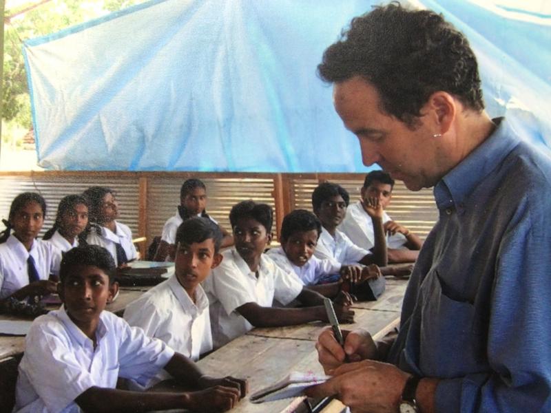Joel Charny, who's been a humanitarian aid worker for 40 years, talks to students at a camp for internally displaced people in northern Sri Lanka in 2005. It's one of his favorite photos, he says, "because this is what I did hundreds of times: interview p Joel Charny, who's been a humanitarian aid worker for 40 years, talks to students at a camp for internally displaced people in northern Sri Lanka in 2005. It's one of his favorite photos, he says, "because this is what I did hundreds of times: interview p