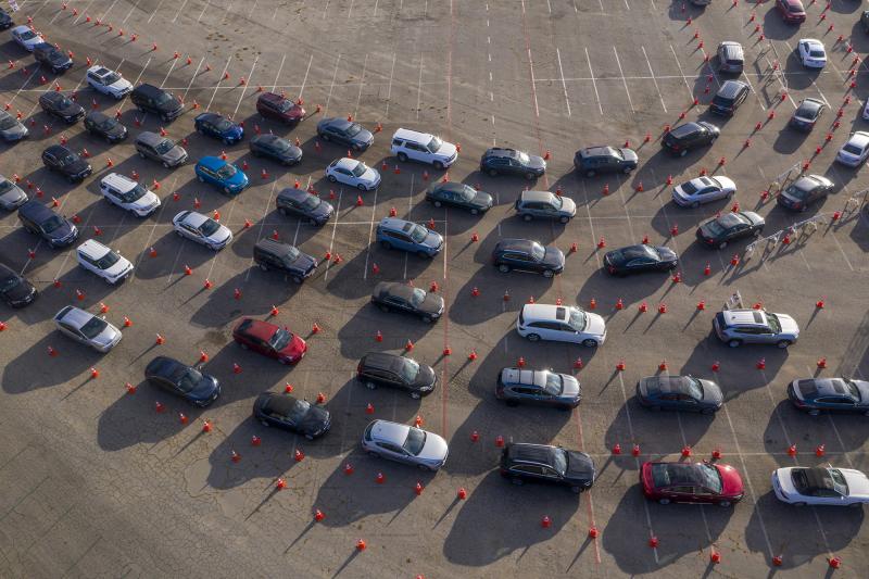 In an aerial view from a drone, cars line up at Dodger Stadium for COVID-19 testing in Los Angeles, California. In an aerial view from a drone, cars line up at Dodger Stadium for COVID-19 testing in Los Angeles, California.