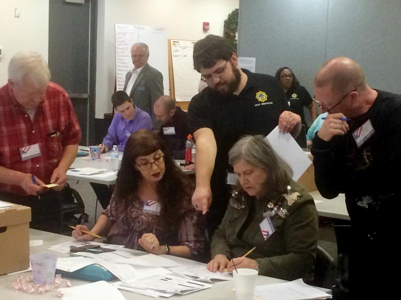 Election officials in Newport News, Va., examine ballots during a recount for a House of Delegates race on Tuesday, Dec. 19, 2017. Election officials in Newport News, Va., examine ballots during a recount for a House of Delegates race on Tuesday, Dec. 19, 2017.