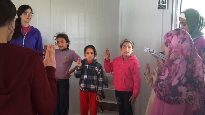 An informal Girl Scout group at the Zaatari refugee camp in Jordan sings: "We want to learn and rise up to fulfill our dreams." An informal Girl Scout group at the Zaatari refugee camp in Jordan sings: "We want to learn and rise up to fulfill our dreams."