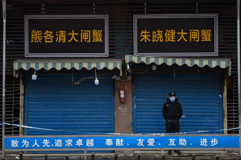 A security guard stands outside the Huanan Seafood Wholesale Market, where the novel coronavirus was detected in Wuhan, China. A security guard stands outside the Huanan Seafood Wholesale Market, where the novel coronavirus was detected in Wuhan, China.