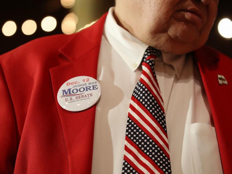 A supporter of Republican senatorial candidate Roy Moore attends a campaign rally at Oak Hollow Farm in Fairhope, Ala., on Dec. 5. Moore faces Democrat Doug Jones on Tuesday. A supporter of Republican senatorial candidate Roy Moore attends a campaign rally at Oak Hollow Farm in Fairhope, Ala., on Dec. 5. Moore faces Democrat Doug Jones on Tuesday.