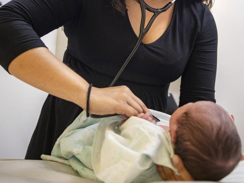 A pediatrician examines a newborn baby in her clinic in Chicago on Tuesday in 2019. In a new policy statement released Monday, the American Academy of Pediatrics says it is putting all its guidance under the microscope to eliminate "race-based" medicine a A pediatrician examines a newborn baby in her clinic in Chicago on Tuesday in 2019. In a new policy statement released Monday, the American Academy of Pediatrics says it is putting all its guidance under the microscope to eliminate "race-based" medicine a