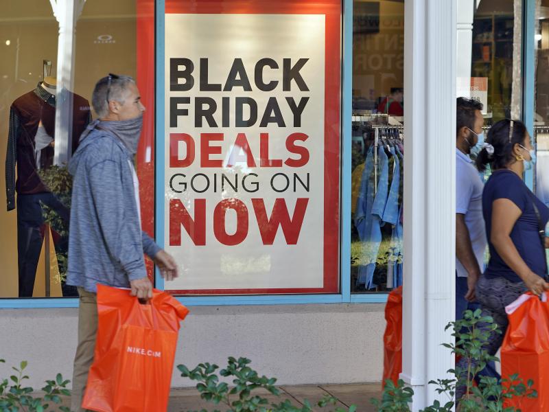 Shoppers wear protective face masks as they look for Black Friday deals at the Ellenton Premium Outlet stores Friday, Nov. 27, 2020, in Ellenton, Fla. Shoppers wear protective face masks as they look for Black Friday deals at the Ellenton Premium Outlet stores Friday, Nov. 27, 2020, in Ellenton, Fla.