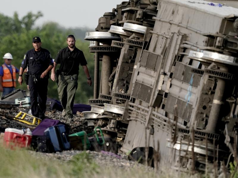 Law enforcement personnel inspect the scene. Law enforcement personnel inspect the scene.