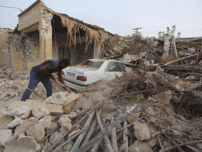 A man cleans up rubble after an earthquake at Sayeh Khosh village in Hormozgan province in Iran, some 620 miles south of the capital Tehran on July 2, 2022. A man cleans up rubble after an earthquake at Sayeh Khosh village in Hormozgan province in Iran, some 620 miles south of the capital Tehran on July 2, 2022.