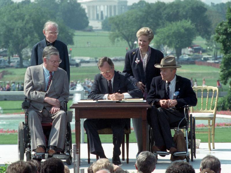 President George H. W. Bush signs the Americans with Disabilities Act on July 26, 1990. President George H. W. Bush signs the Americans with Disabilities Act on July 26, 1990.