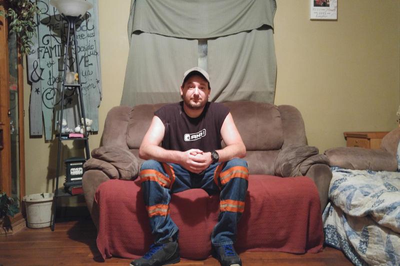Branham wears reflective mining pants in his home in Elkhorn City, Ky. Branham has advanced stage black lung and was forced to quit mining earlier this year. Branham wears reflective mining pants in his home in Elkhorn City, Ky. Branham has advanced stage black lung and was forced to quit mining earlier this year.