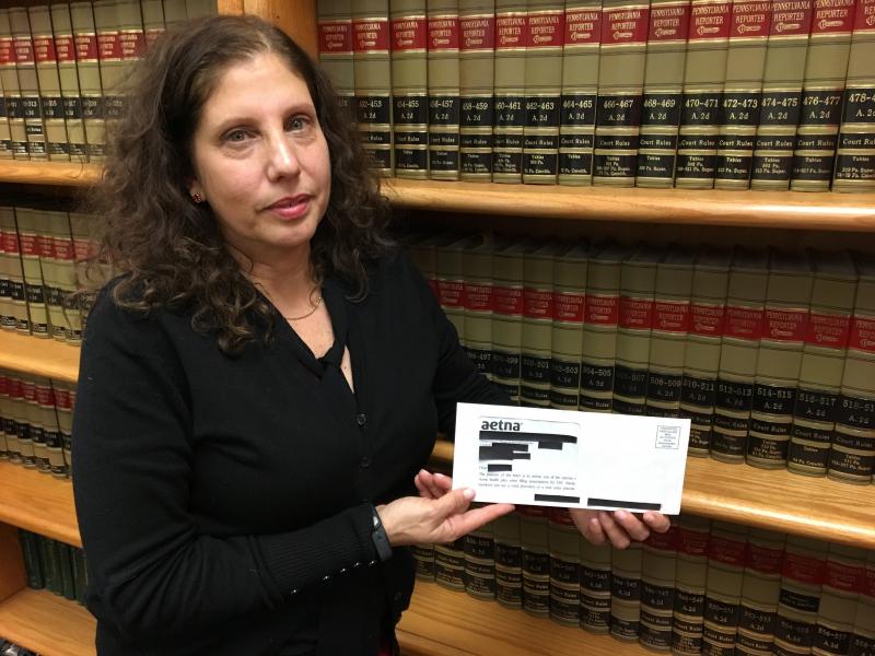 Ronda Goldfein, attorney and executive director of the AIDS Law Project of Pennsylvania, holds an envelope that revealed a person's HIV status through the clear window. Ronda Goldfein, attorney and executive director of the AIDS Law Project of Pennsylvania, holds an envelope that revealed a person's HIV status through the clear window.