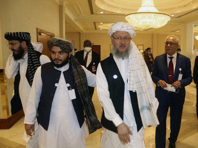 Abdul Salam Hanafi (right), a member of the Taliban negotiating team, heads to the opening session of peace talks between the Afghan government and the Taliban in Doha, Qatar, on Saturday. Abdul Salam Hanafi (right), a member of the Taliban negotiating team, heads to the opening session of peace talks between the Afghan government and the Taliban in Doha, Qatar, on Saturday.