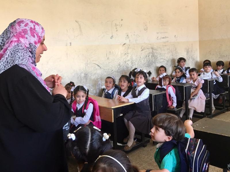 A teacher greets students on the first day of elementary school in Mosul, where regular classes have started for the first time since ISIS took over the northern Iraqi city three years ago. Hundreds of schools were damaged or destroyed in the fighting to A teacher greets students on the first day of elementary school in Mosul, where regular classes have started for the first time since ISIS took over the northern Iraqi city three years ago. Hundreds of schools were damaged or destroyed in the fighting to