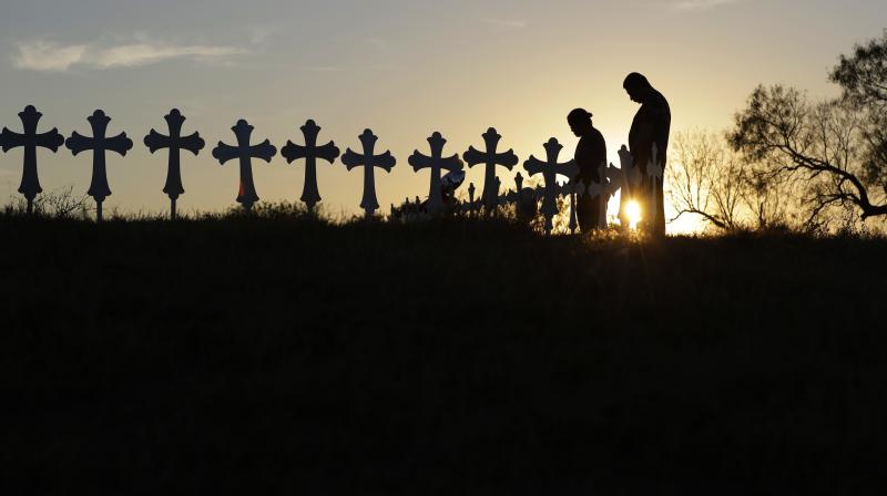 Kenneth and Irene Hernandez pay their respects as they visit a makeshift memorial with crosses placed near the scene of a shooting at the First Baptist Church of Sutherland Springs, Texas. A man opened fire inside the church in the small South Texas commu Kenneth and Irene Hernandez pay their respects as they visit a makeshift memorial with crosses placed near the scene of a shooting at the First Baptist Church of Sutherland Springs, Texas. A man opened fire inside the church in the small South Texas commu