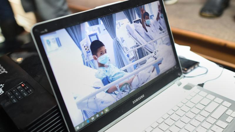 Local government workers on Wednesday display the newly released video footage of the rescued soccer players, who are currently recuperating in hospital beds. Local government workers on Wednesday display the newly released video footage of the rescued soccer players, who are currently recuperating in hospital beds.