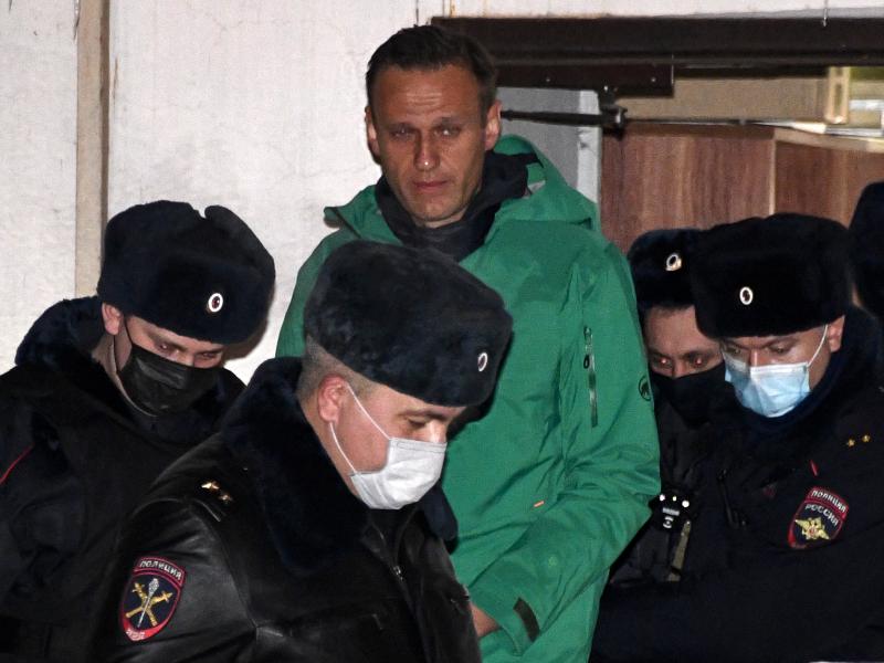Opposition leader Alexei Navalny is escorted out of a police station in Khimki, outside Moscow, following the court ruling that ordered him jailed for 30 days. Opposition leader Alexei Navalny is escorted out of a police station in Khimki, outside Moscow, following the court ruling that ordered him jailed for 30 days.